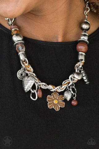 Image of "Charmed, I Am Sure - Brown" necklace on a woman with a black tee shirt.