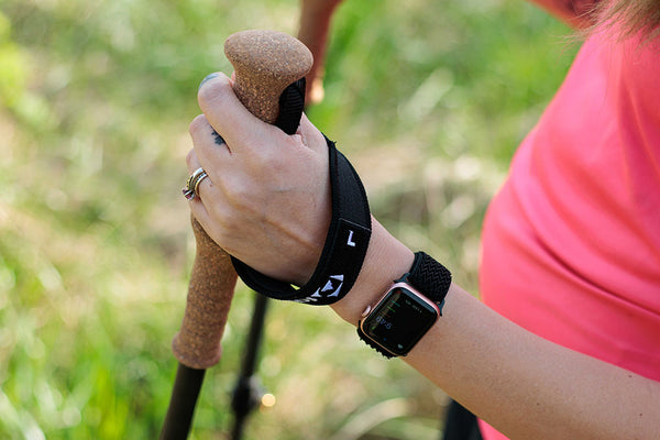 Close up of trekking pole grips being held in each hand