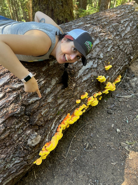 Becky leabing over downed log with fungi