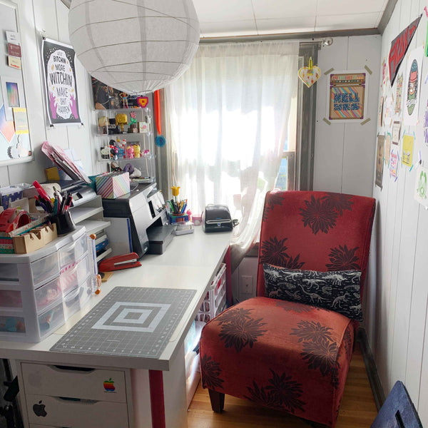 Marshmueller Studio shipping area with a counter, printer, and red chair