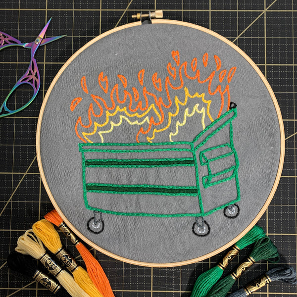 Dumpster Fire Embroidery Kit with hoop and skeins of thread and embroidery scissors
