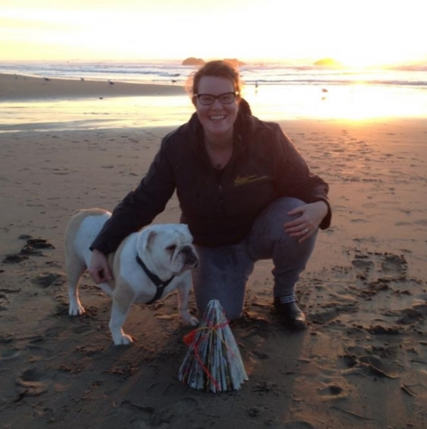 Sho Roberts on the beach with Maggie Mae, her bulldog