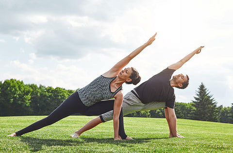 partners are doing yoga together