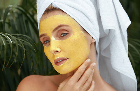 Lady has applied turmeric face pack on her face