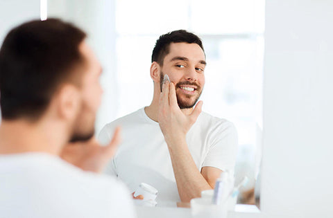 men is applying face cream