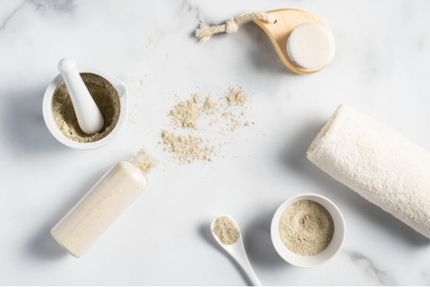 Chandan powder, wooden stick, cream and serum on table