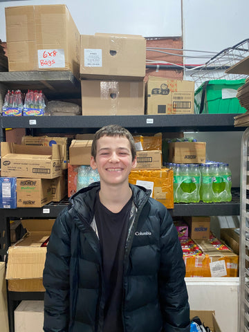 This is me in front of the first shipment of snacks