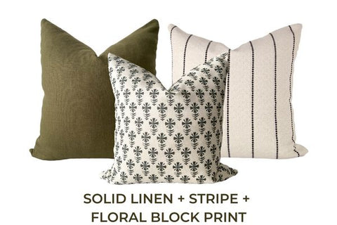 Three throw pillows - one solid, one striped, one patterned