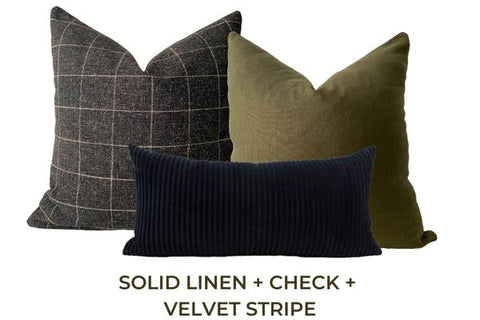 Three throw pillows in grey, black and green