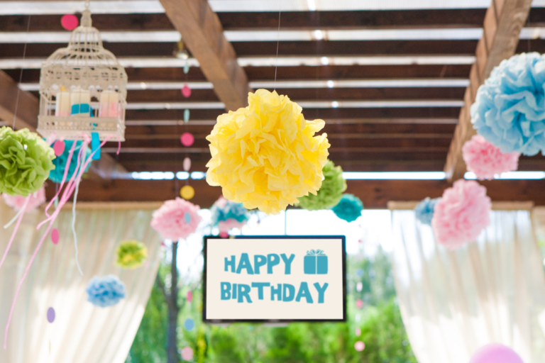 A birthday sign and other ornaments hanging from the celling