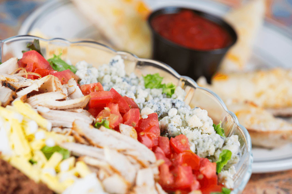 Tuna salad with tomatoes in transparent bowl.