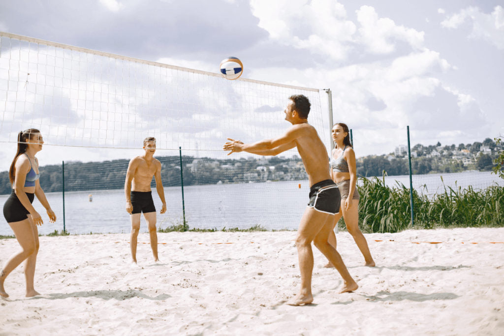 Friends playing beach volleyball.