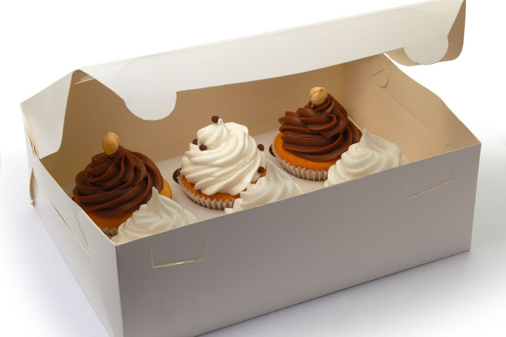 A box of cupcakes with different frostings.