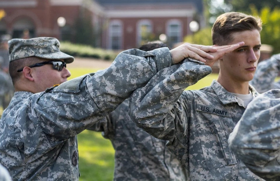 Drill Sergeant instructs (ROTC) Cadet how to salute properly.