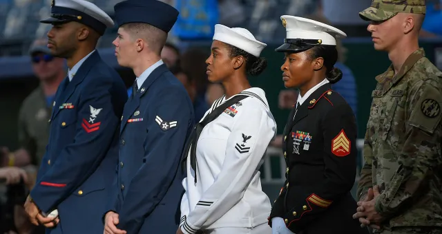 Service members  are honored in a pregame ceremony for Armed Forces Night in Kansas City, Missouri.