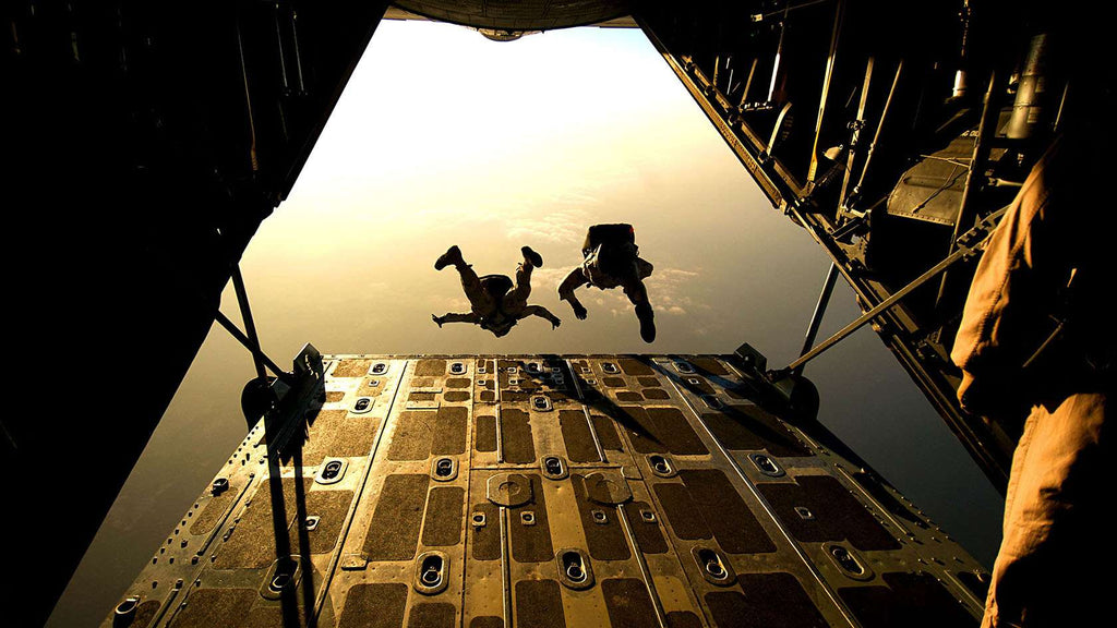 Pararescuemen jumping out of plane