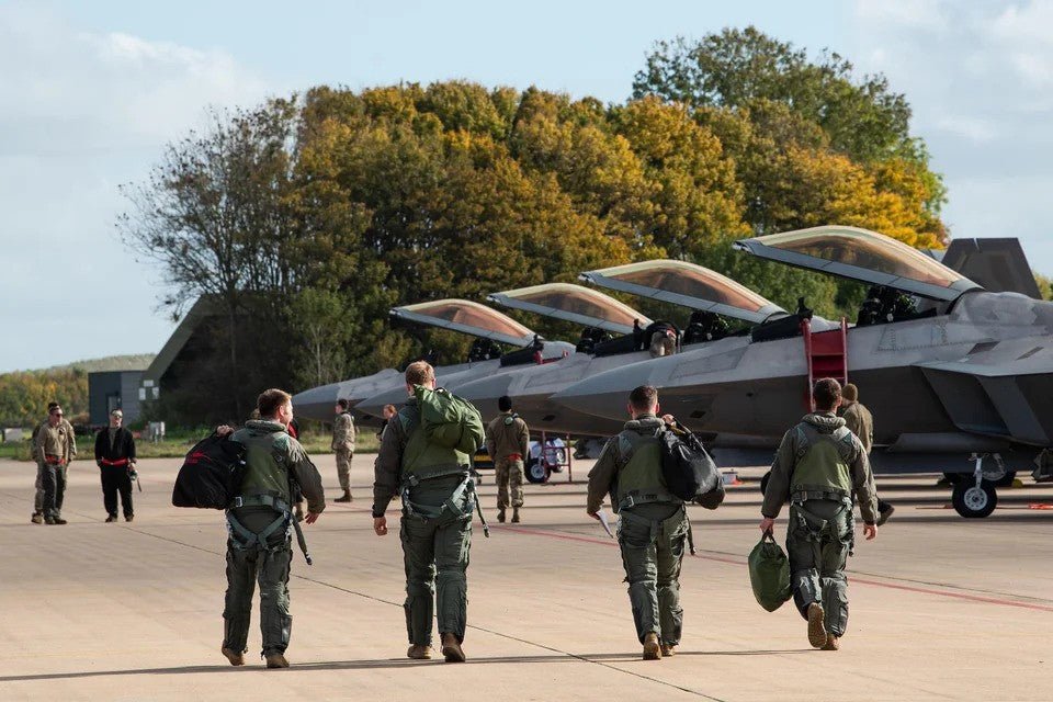 U.S. Air Force F-22 Raptor pilots walking towards their Jets