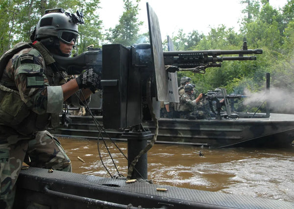 United States Navy Special Warfare Combat Crewman (SWCC) fires M240