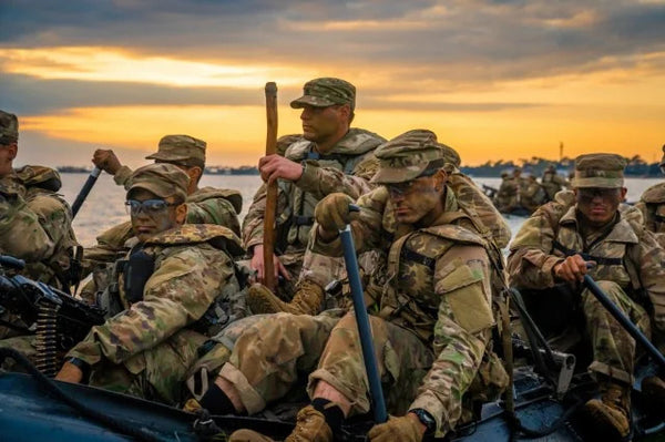 Candidates at Fort Benning's U.S. Army Ranger School paddle assault boats along a waterway in Florida Dec 2019 during the "swamp" phase of Ranger training.