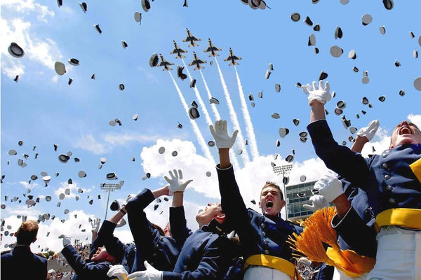 Cadets of the U.S. Air Force Academy Class of 2003 celebrate graduation as the Air Force Thunderbirds fly overhead.