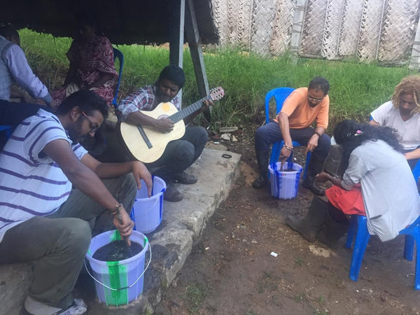 man playing guitar while biodynamic microbial solution is prepared