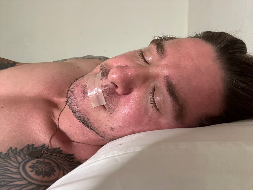 Image of a man sleeping peacefully with sleep tape applied, demonstrating the use of the tape to promote nasal breathing and enhance overall sleep quality.