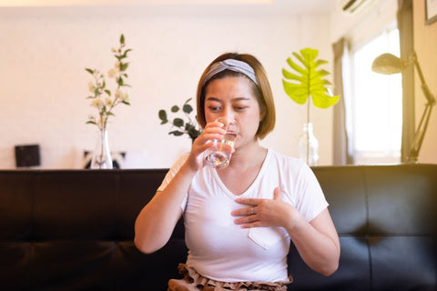 A person drinking from a glass