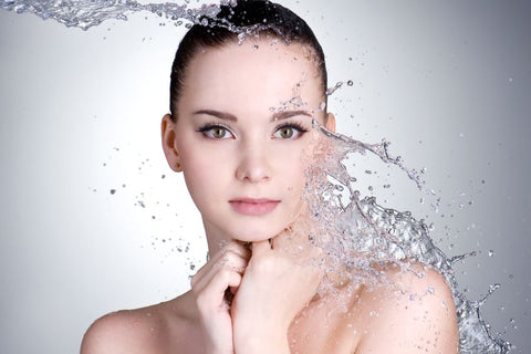 A person with water splashing around her face