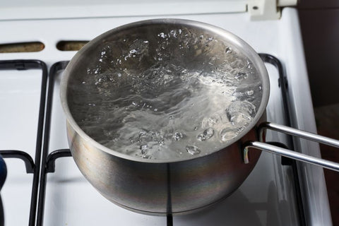A pot of boiling water on a stove