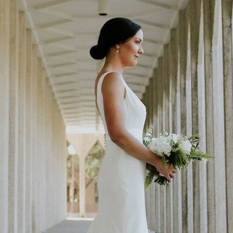 a low bun with a sabina motasem wedding dress