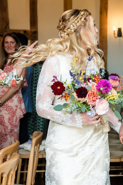 Real bride Suzanne wears a boho plait, illustrating easy bridal hairstyles