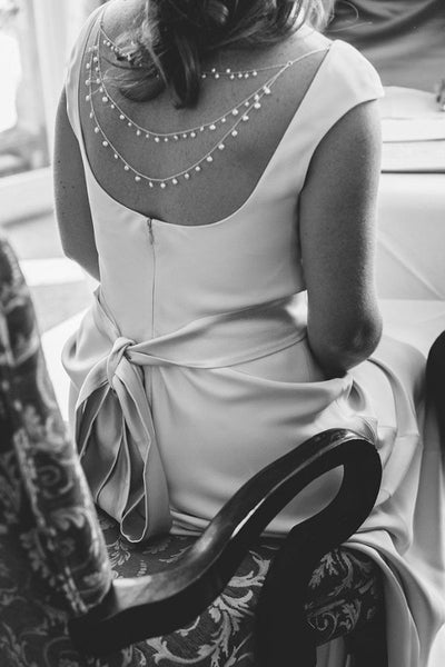 A sabina motasem bride wearing a back necklace