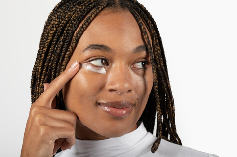 Woman putting on Milk Made Skin eye cream