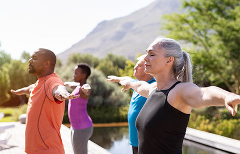 some women and men doing exercise in the heat