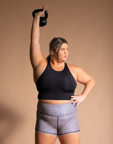 Carly Compton lifting kettlebell in JOLYN activewear