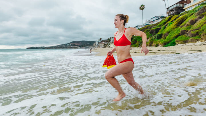 woman running in lifeguard bikini