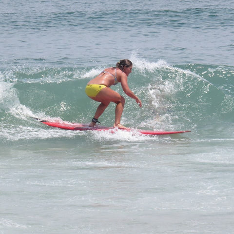 woman surfing wearing a Jolyn surf bikini