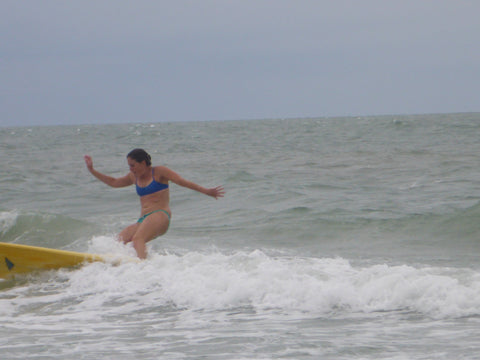 woman surfing wearing a Jolyn surf bikini