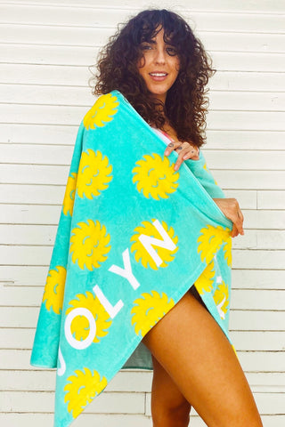 a woman wrapped in a JOLYN beach towel