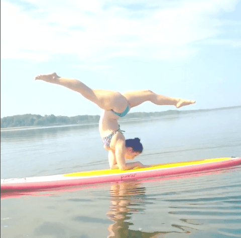 Irene Pappas, yoga pose, JOLYN bikini on a surfboard