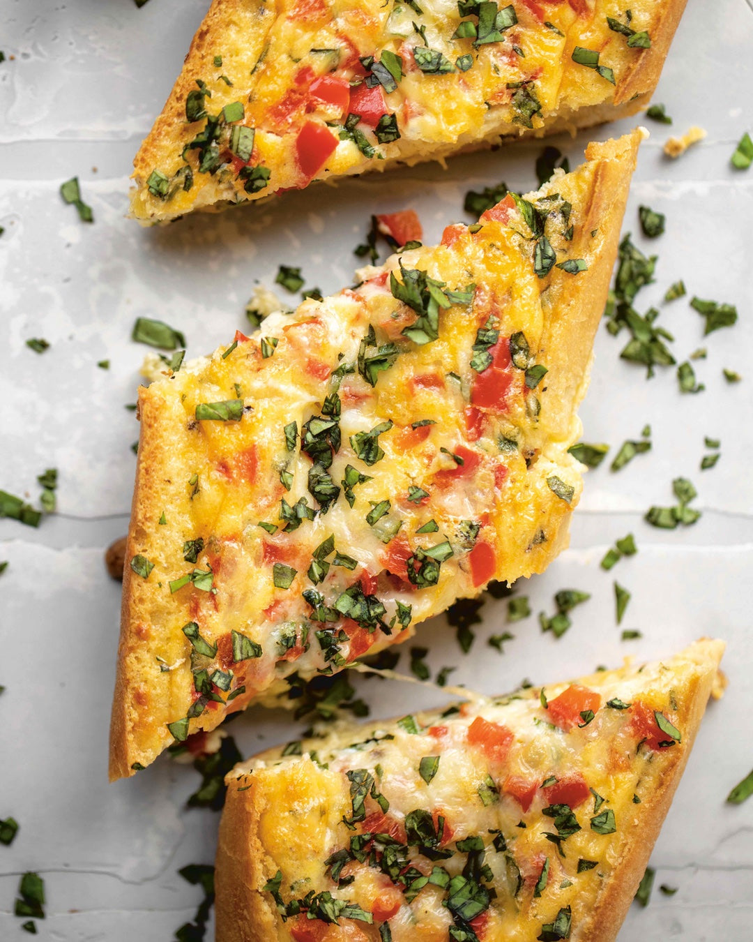A flexible baked egg baguette recipe made with a creamy egg, cheese, seasonings, and diced vegetables filling. | peteandgerrys.com