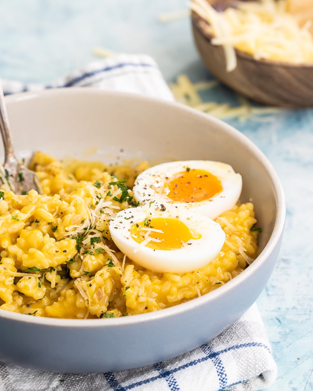A hearty fall recipe for homemade butternut squash risotto topped with Parmesan cheese and soft-boiled eggs. | peteandgerrys.com