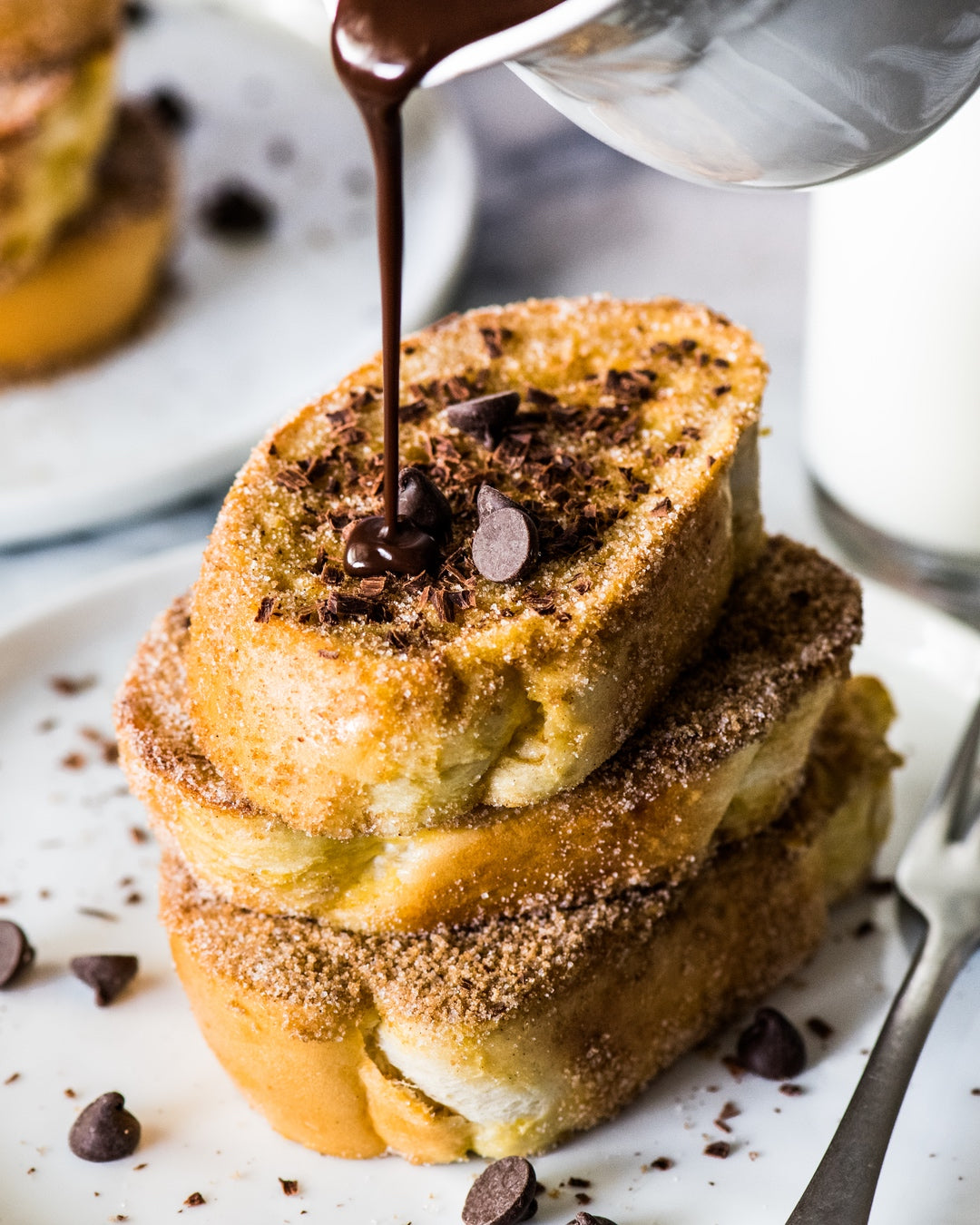 French toast coated with cinnamon sugar topped with Mexican chocolate sauce