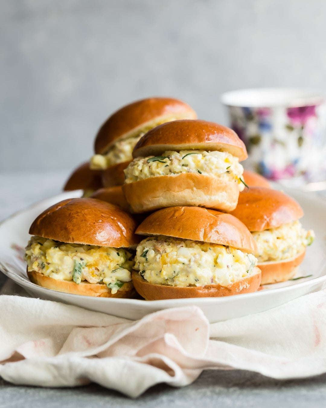 A classic egg salad recipe made with mayo, green onions, and mustard and served on buttery mini brioche rolls. | peteandgerrys.com