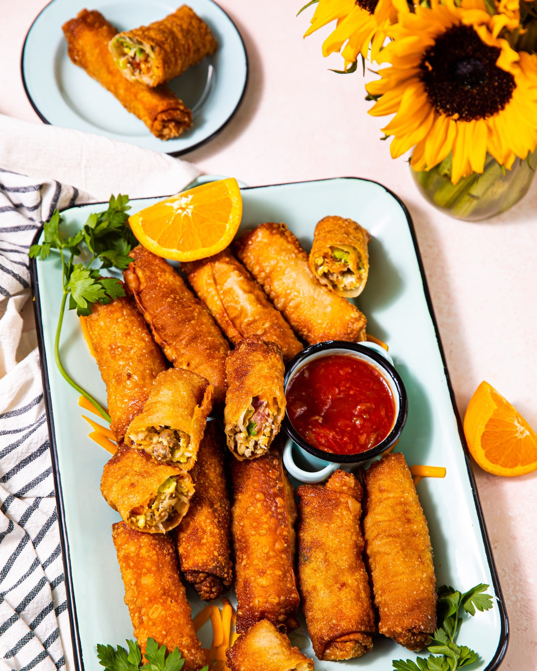 A crowd-friendly recipe for breakfast egg rolls filled with breakfast sausage, shredded cheese, and scrambled eggs. | peteandgerrys.com