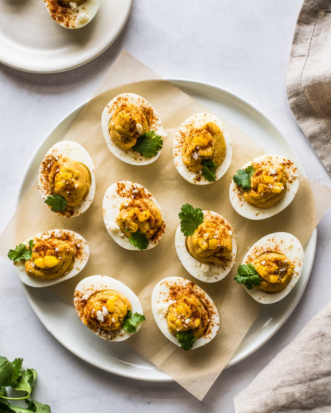 Deviled eggs topped with Mexican street corn made with chili, chipotle powder and cotija cheese for a protein packed snack for any crowd. | peteandgerrys.com