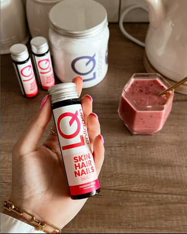 female hand holding LQ liquid collagen supplements