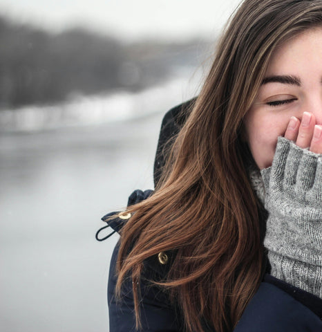 female in the winter wearing grey gloves