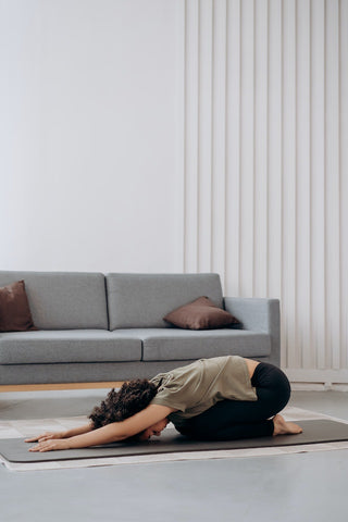 female doing yoga at home