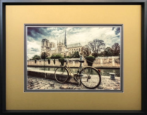 Framed photograph with wide gold matte around